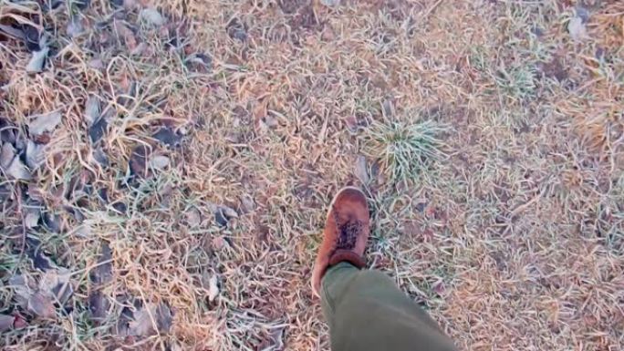 一个穿靴子的男人在村子里的地上行走