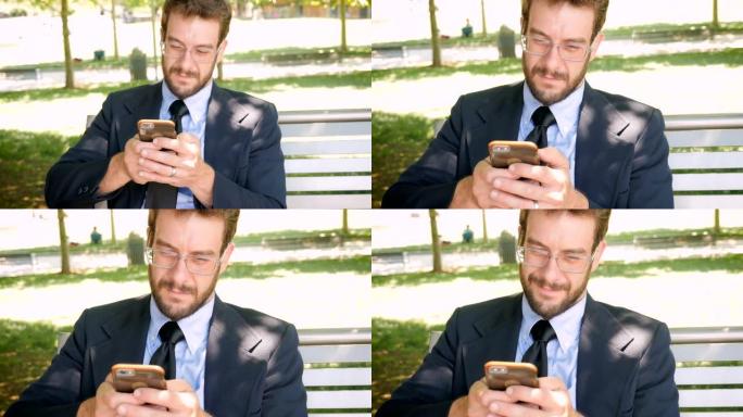成功的推销员坐在公园的长椅上玩智能手机