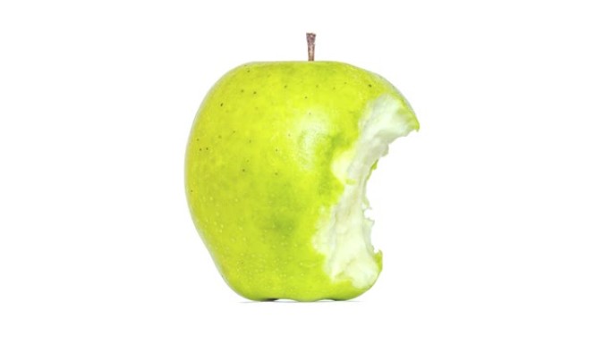 创意4k视频，一个绿色苹果微距特写镜头隔离在白色背景上，迅速吃掉了一个存根。从整体到存根的青苹果。停