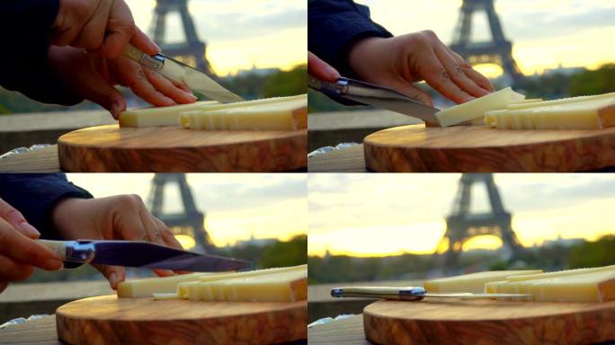 在埃菲尔铁塔的背景上切下硬奶酪的刀