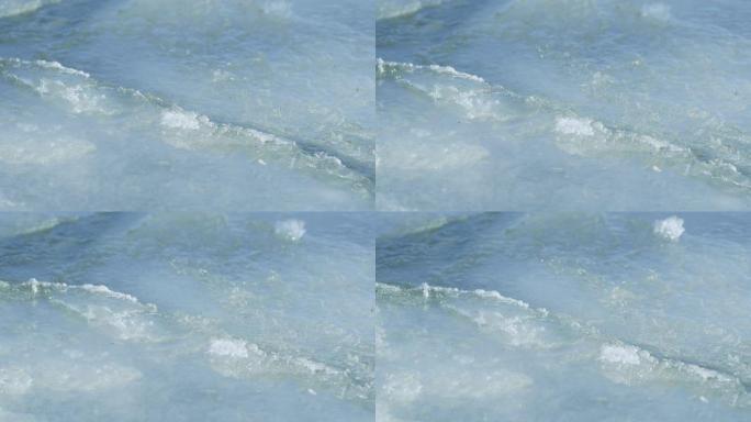 近距离拍摄的浮冰片相互磨碎，并在海面上融化。
