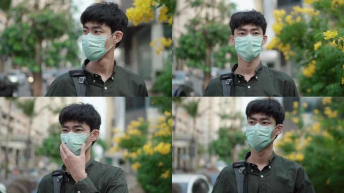 亚洲青年男子戴防护口罩