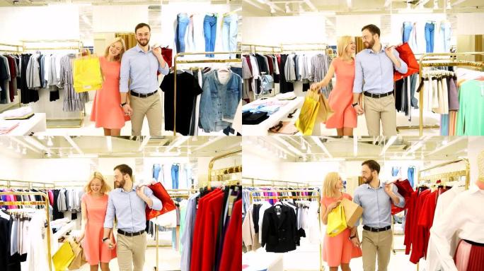 年轻幸福的夫妇在时装店一起买衣服。慢动作
