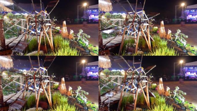 泰国节日之夜的旋转水旧竹木轮