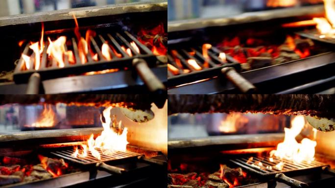 街头食品咖啡馆的金属网格下的炉子和燃烧的火