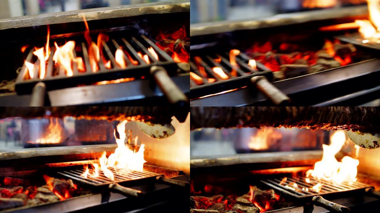 街头食品咖啡馆的金属网格下的炉子和燃烧的火