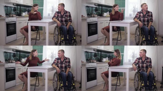 压力大的情况下，坐在轮椅上的残疾人在与紧张的妻子吵架时感到沮丧，在厨房里一个不幸的家庭里诅咒并挥舞着