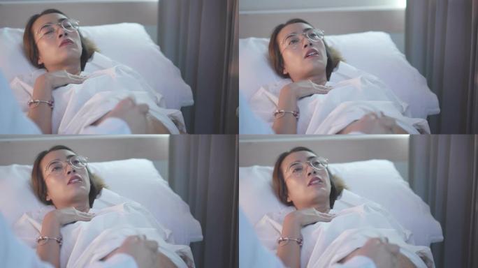 一名亚洲女性孕妇躺在床上，一名女医生在医院诊所扫描婴儿时发出超声波