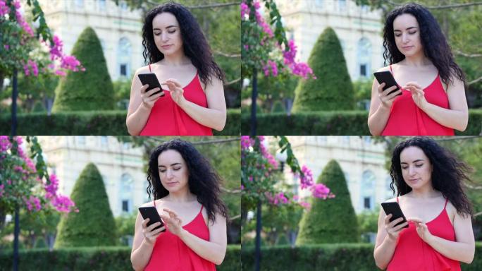 欧洲年轻女孩或女人可爱开朗的女孩黑发在智能手机上打字短信，女人在电话上聊天。年轻女子通过手机打电话。