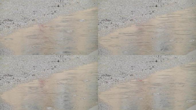 Rain on asphalt or tarmac road creating ripples, h