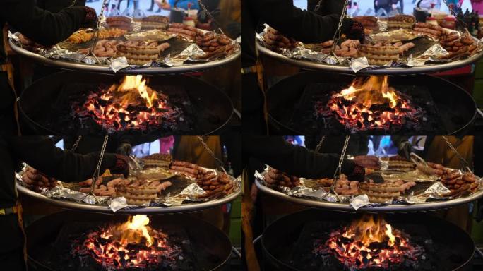 不同类型的烤香肠在一个大锅里用明火油炸。街头咖啡馆为博览会上的游客准备款待。