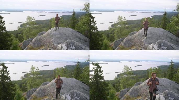 男子在努伊斯基奥国家公园的岩石上行走，可以看到湖景