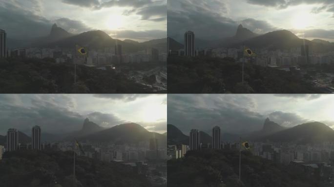 一架无人机在森林中挥舞着阳光照耀下的巴西国旗，背景是城市建筑，里约热内卢de Janeiro