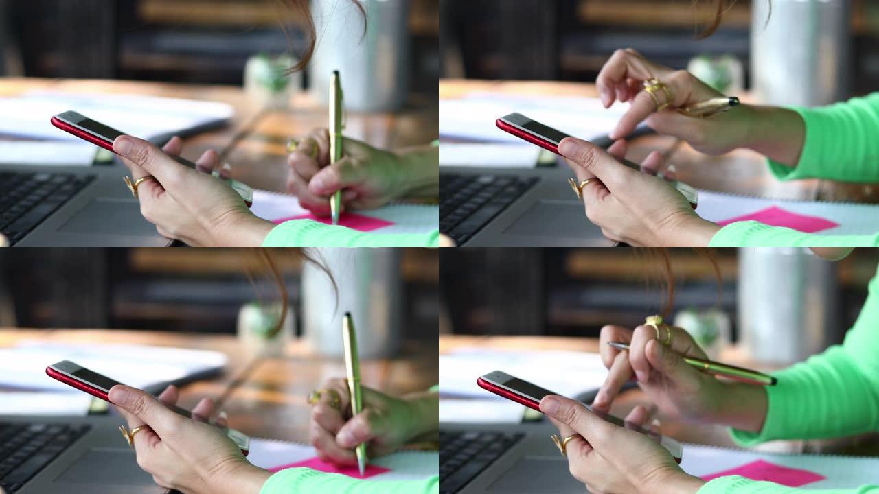 亚洲商界女性正在使用移动和触摸智能手机进行通信，女性在咖啡店使用笔记本工作