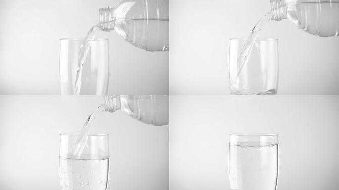 将淡水倒入白色背景的透明饮料杯中。清凉的饮料和点心。
