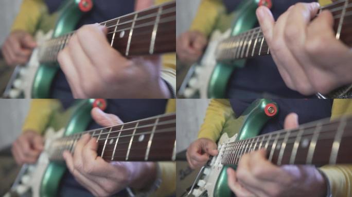 吉他大师的手在脖子上滑动的特写镜头，在金属绿色老式电吉他上弹奏和弦，音阶和独奏