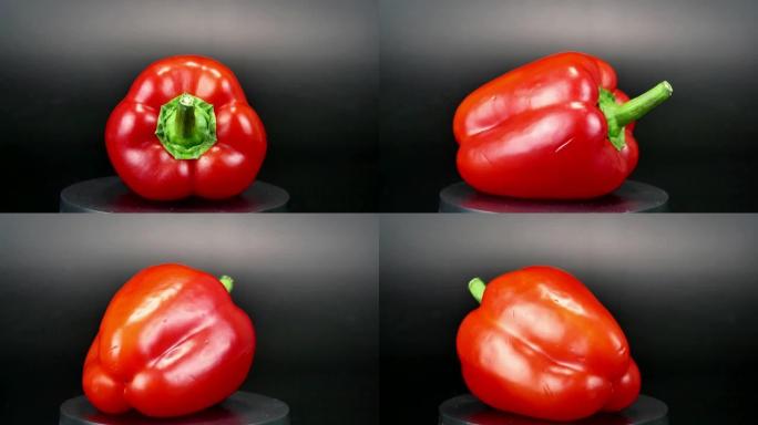 红辣椒在黑色背景上旋转。食品。视频。