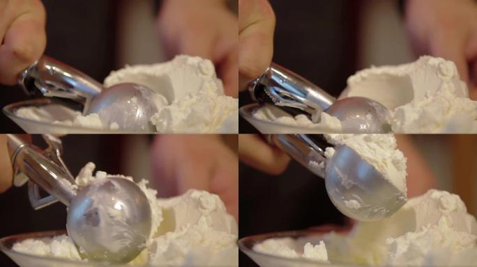 在碗里舀冰淇淋的特写镜头。食品概念。