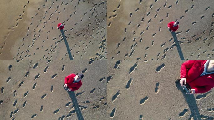男子在热带海滩上驾驶无人机的鸟瞰图