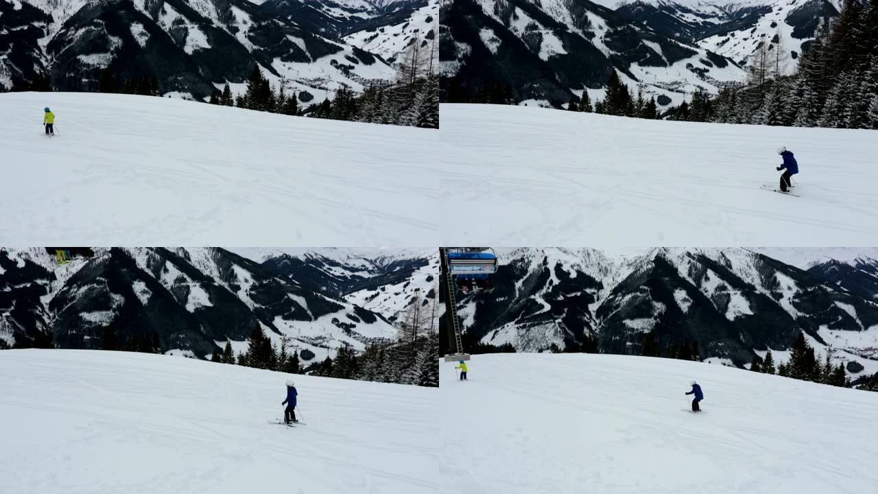 孩子们，在阳光明媚的日子在冬季滑雪场滑雪，欣赏风景