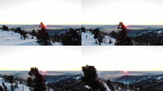 风景如画的橙色日落映在高地雪上