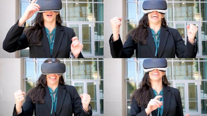 使用VR耳机在虚拟现实中工作的女商人庆祝成功