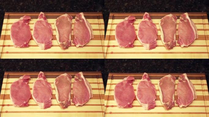 自上而下的视图，在准备烧烤的木制切菜板上新鲜的未煮熟的生去骨里脊肉猪排