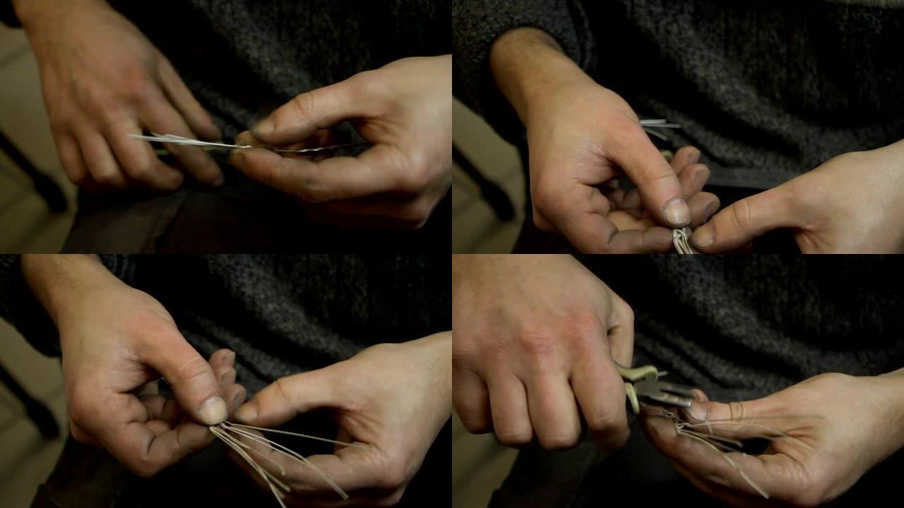 编织银手镯的特写，珠宝大师的手制作新产品，选择性聚焦