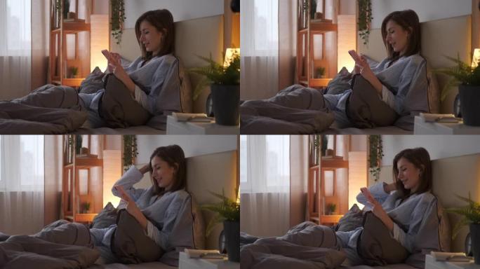 女人在床上用手机发短信