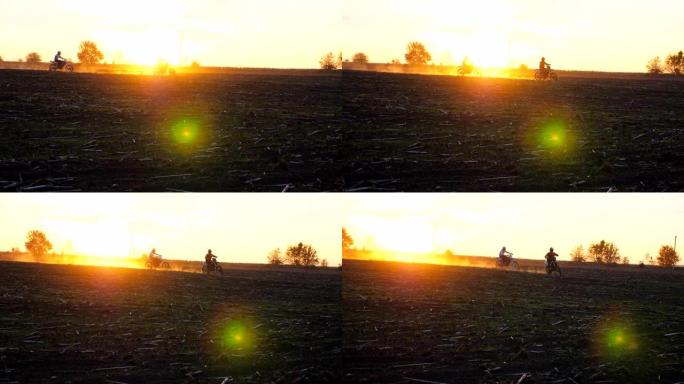 骑摩托车的人骑着摩托车穿过田野，留下灰尘痕迹。朋友们在日落时积极休息户外驾驶强大的摩托车。骑自行车的