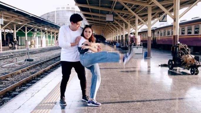 年轻的潮人在等待火车时在火车站做自由式街舞。亚洲男人和女人。