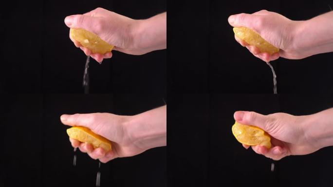 慢动作柠檬。手挤压柠檬汁。