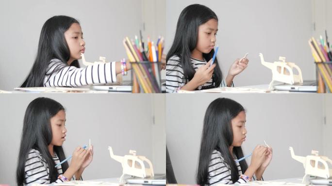 亚洲小女孩制作木制模型选择聚焦浅景深