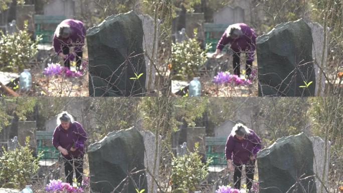 在墓地探望坟墓的老年妇女。辛菲罗波尔的阿布达尔公墓。
