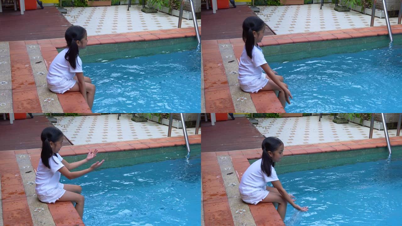 女儿喜欢在游泳池边玩耍泼水