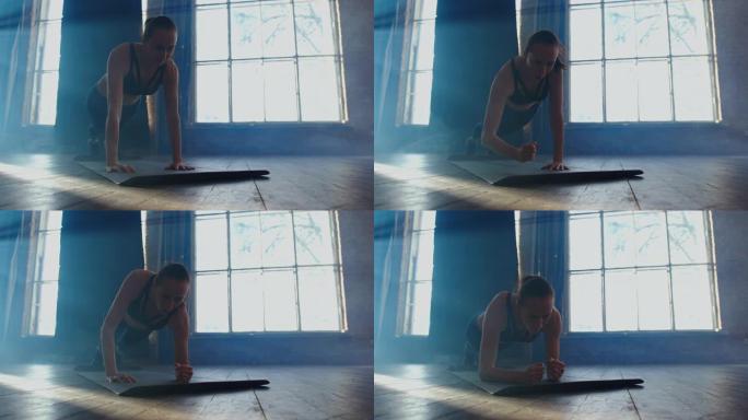 在健身房做健身普拉提木板锻炼锻炼的女性。运动服中的运动女孩模特在瑜伽垫上锻炼，在室内铺板