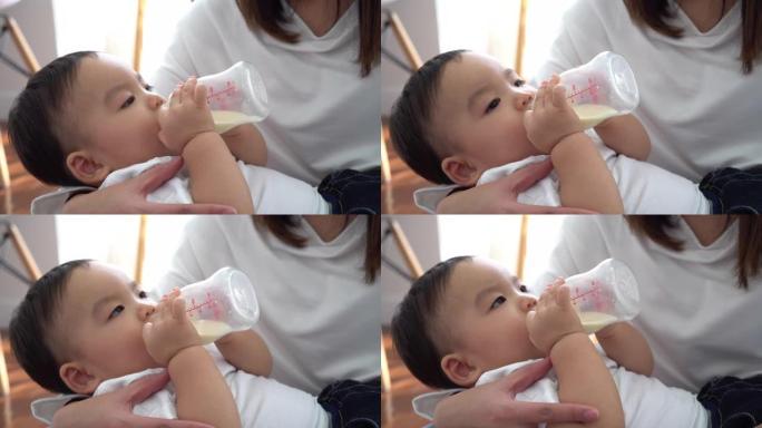 亚洲妈妈用奶瓶喂养男婴