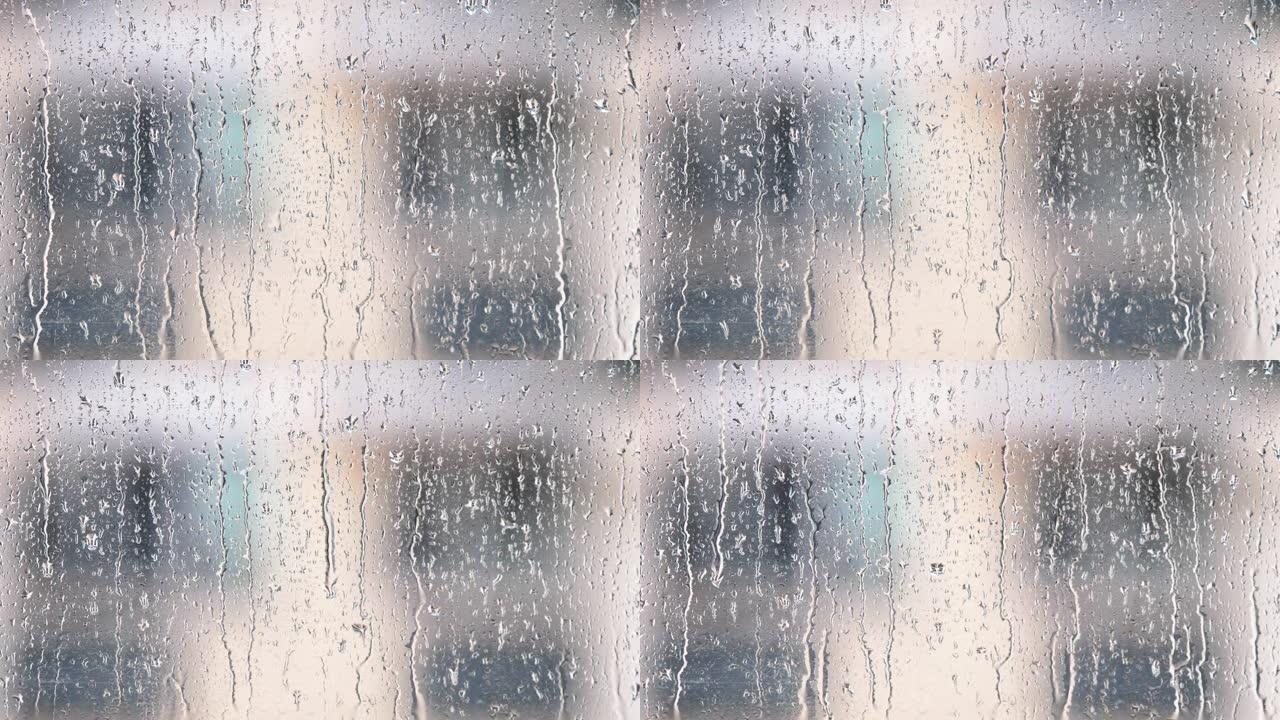 雨滴在窗户玻璃表面，建筑背景模糊，4k电影，b卷镜头。