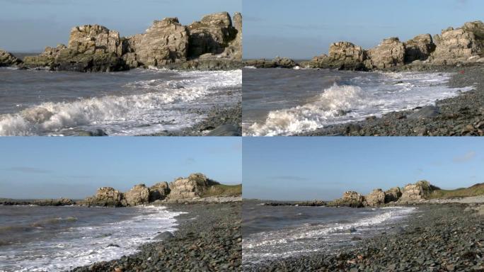 在一个明亮的大风天，岩石苏格兰海滩上的海浪