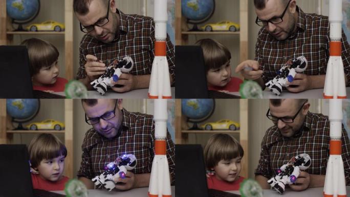 男孩和老师，在现代教室里组装机器人。爸爸带着小儿子在家组装机器人。教育科学，技术儿童，编程电子机器人