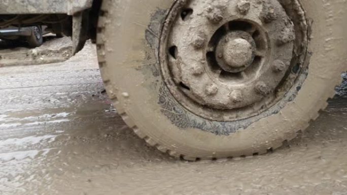 穿过泥泞的卡车车轮特写镜头。