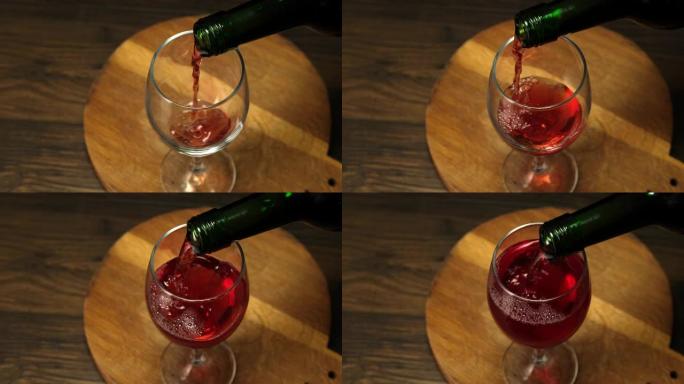 熟练的侍酒师将红酒从瓶子倒入玻璃杯中。
