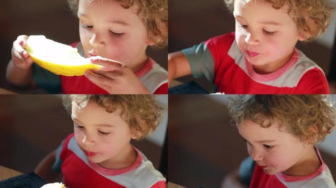 小孩咬一口瓜果幼儿吃水果用胳膊擦嘴