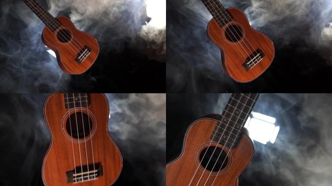 红木夏威夷四弦琴吉他孤立在黑色背景下，有烟