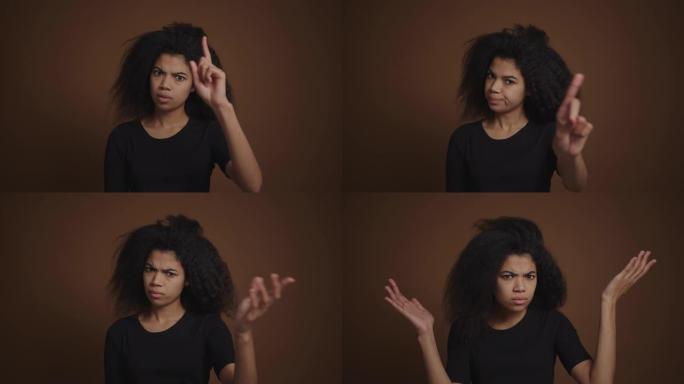 恼怒的非洲裔美国女孩指责并禁止用手指指着相机