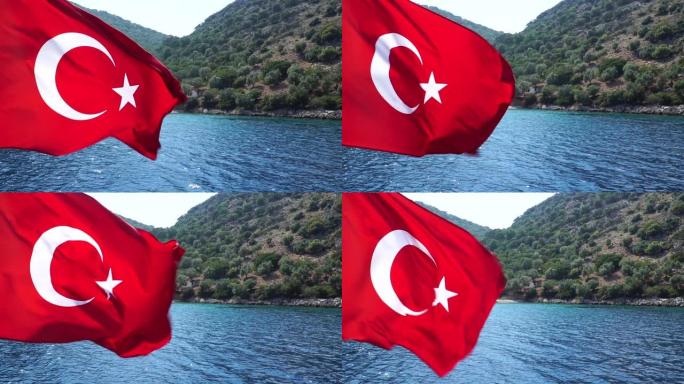 慢动作。土耳其国旗随风飘扬。背景上的海洋和山脉。