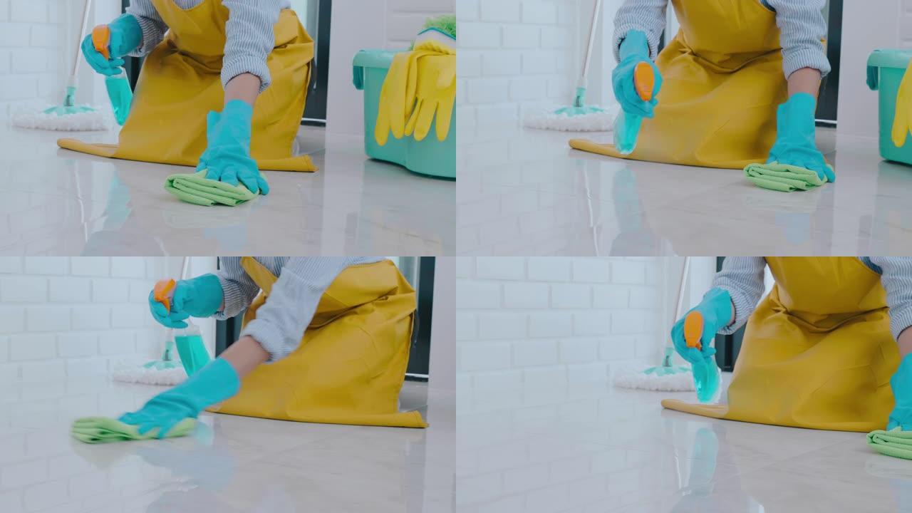 年轻的亚洲妇女打扫房子她的地板去除地板上的污渍借助喷雾保持概念的特殊清洁
