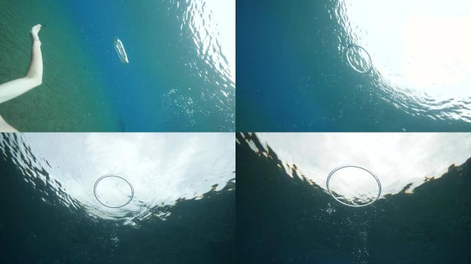 一个戴着面具的男人在水下制作泡泡环的自拍视频。