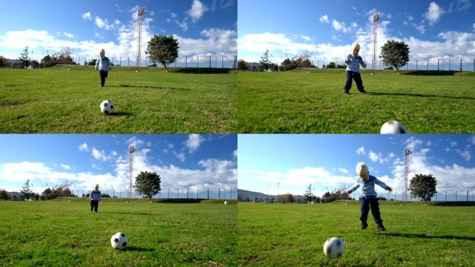 三岁的孩子在足球场上带球奔跑