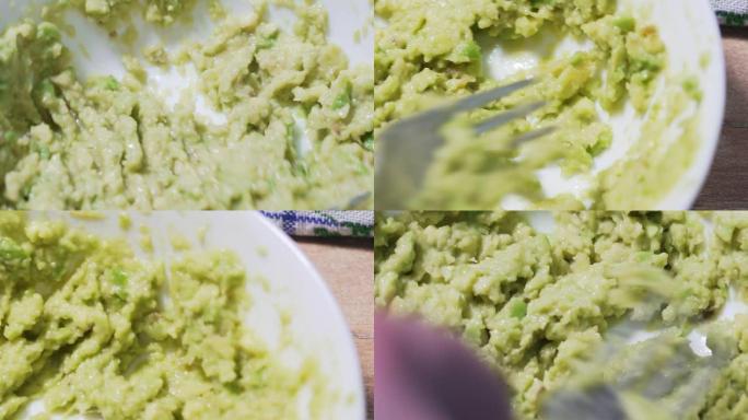 鳄梨色拉酱食谱，第三步。小心搅拌碎的鳄梨在白色盘子里，静态微距拍摄。健康的墨西哥传统食品从天然产品4